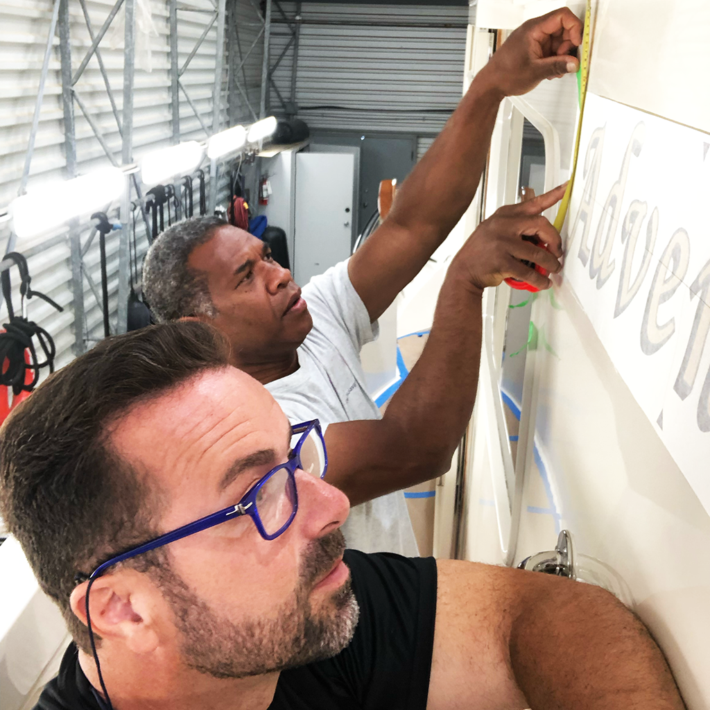 Sasa Sanjic installing boat name with his coworker
